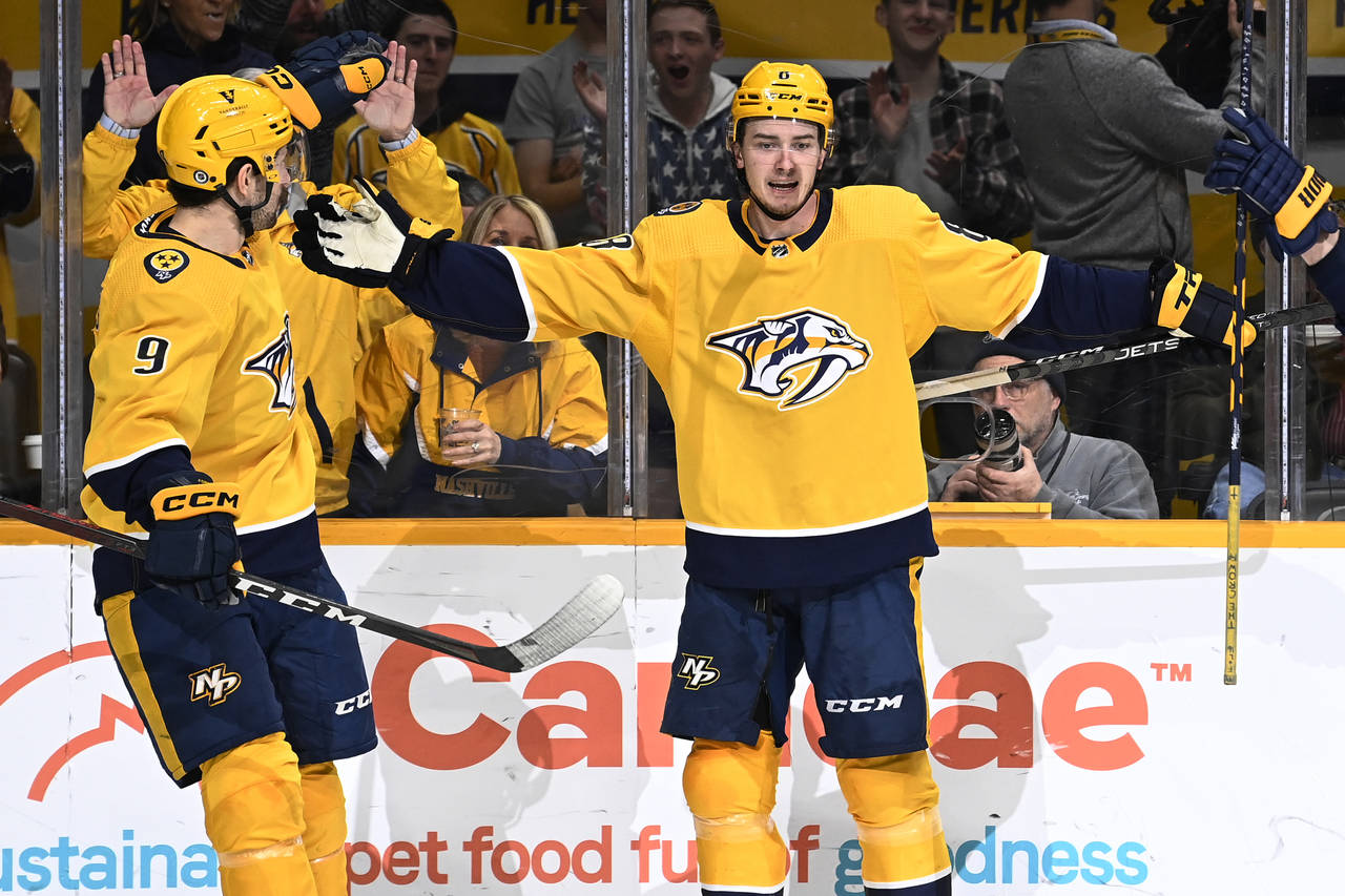 Nashville Predators center Cody Glass (8) celebrates with left wing Filip Forsberg (9) after Glass ...