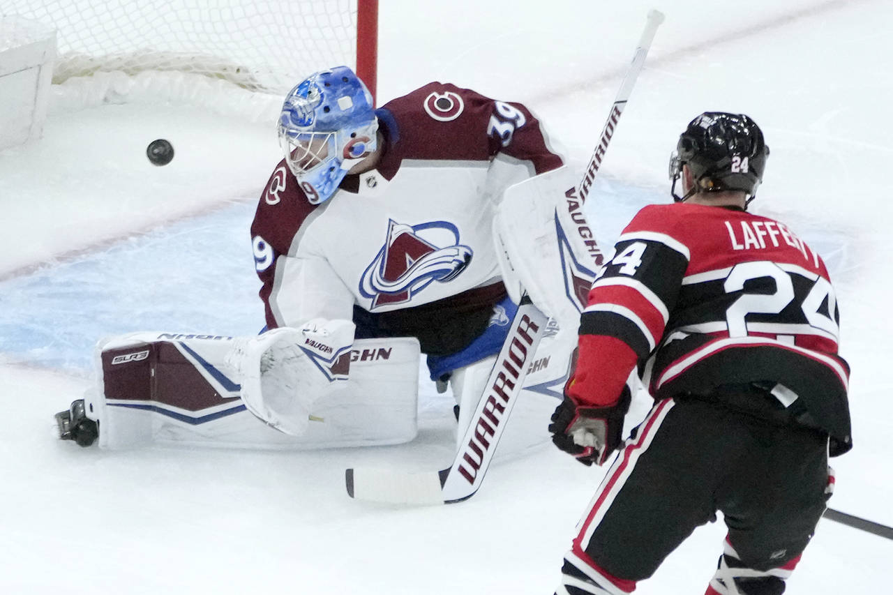 Chicago Blackhawks' Sam Lafferty (24) watches his shot score past Colorado Avalanche goaltender Pav...