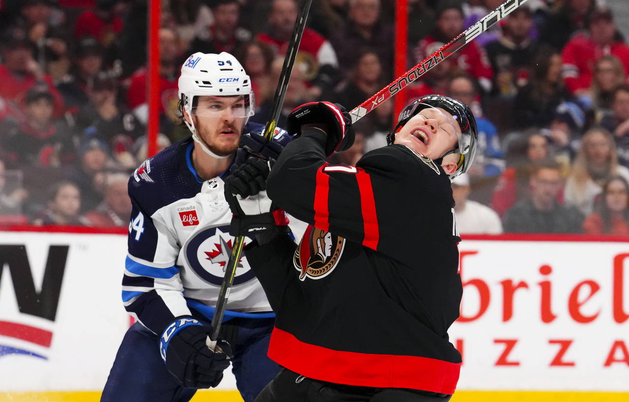 Ottawa Senators left wing Brady Tkachuk (7) reacts after a stick-check by Winnipeg Jets defenseman ...