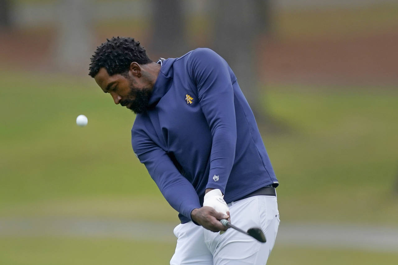 FILE - North Carolina A&T's J.R. Smith chips from the 17th fairway during the first round of the Ph...
