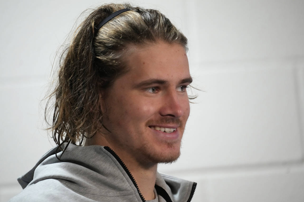 Los Angeles Chargers quarterback Justin Herbert jokes with reporters during a news conference after...