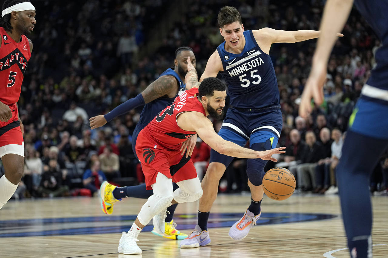 Toronto Raptors guard Fred VanVleet (23) works towards the basket while defended by Minnesota Timbe...