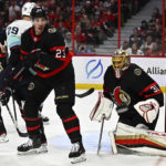 
              A rebound bounces away from Ottawa Senators goaltender Anton Forsberg (31) as defenseman Travis Hamonic (23) and Seattle Kraken defenseman Vince Dunn (29) play in front of the net during first-period NHL hockey game action in Ottawa, Ontario, Saturday, Jan. 7, 2023. (Justin Tang/The Canadian Press via AP)
            