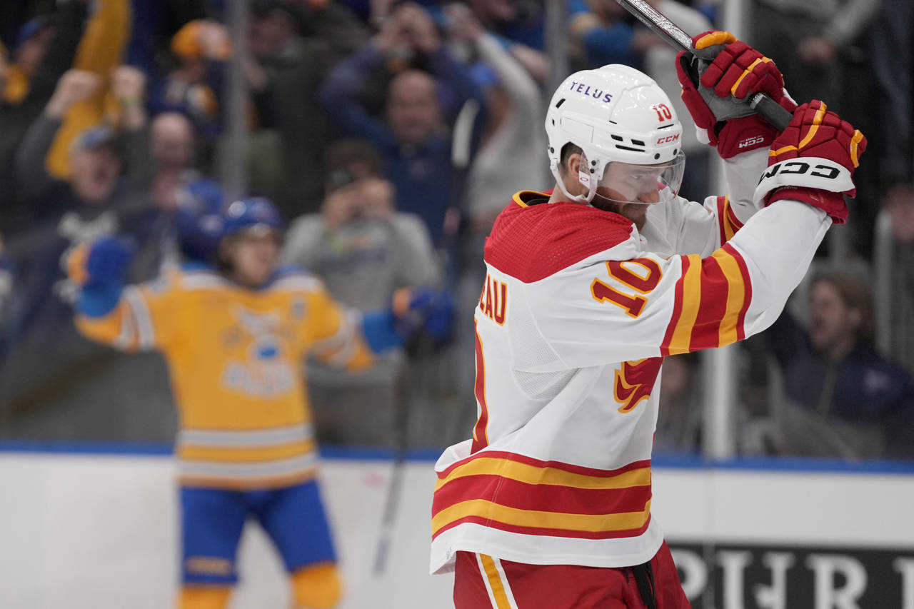 Calgary Flames' Jonathan Huberdeau (10) reacts after St. Louis Blues' Robert Thomas, left, scored d...