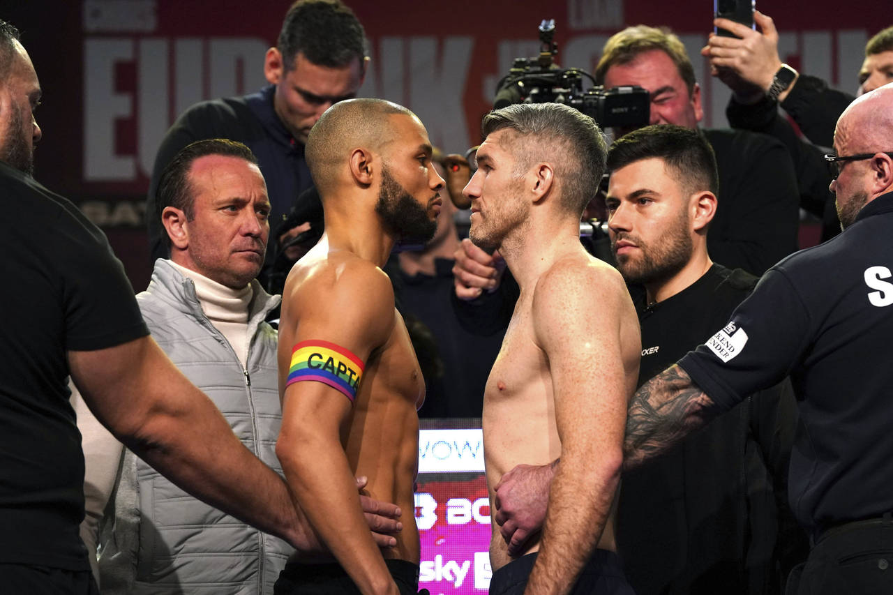 Britain's Chris Eubank Jr, left and Liam Smith look on, during the weigh-in ahead of their middlewe...