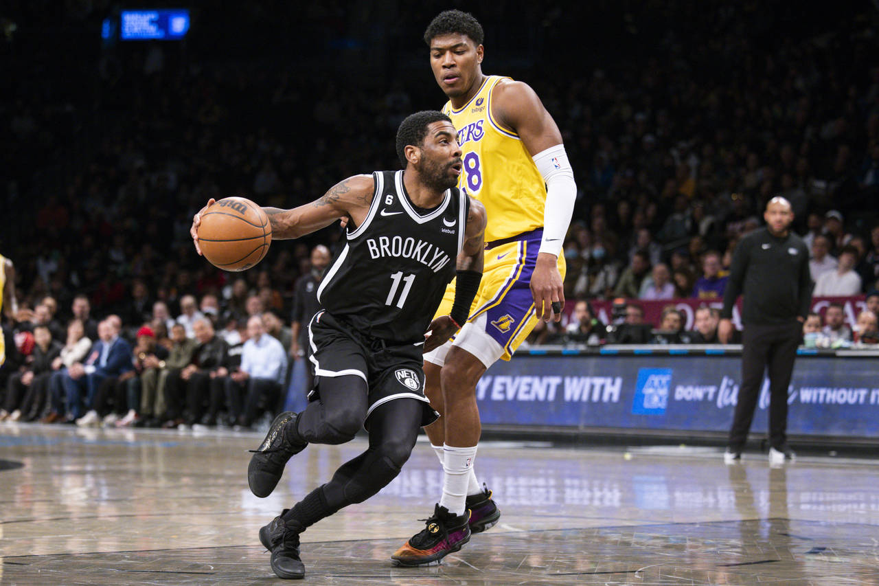 Brooklyn Nets guard Kyrie Irving (11) drives past Los Angeles Lakers forward Rui Hachimura (28) dur...