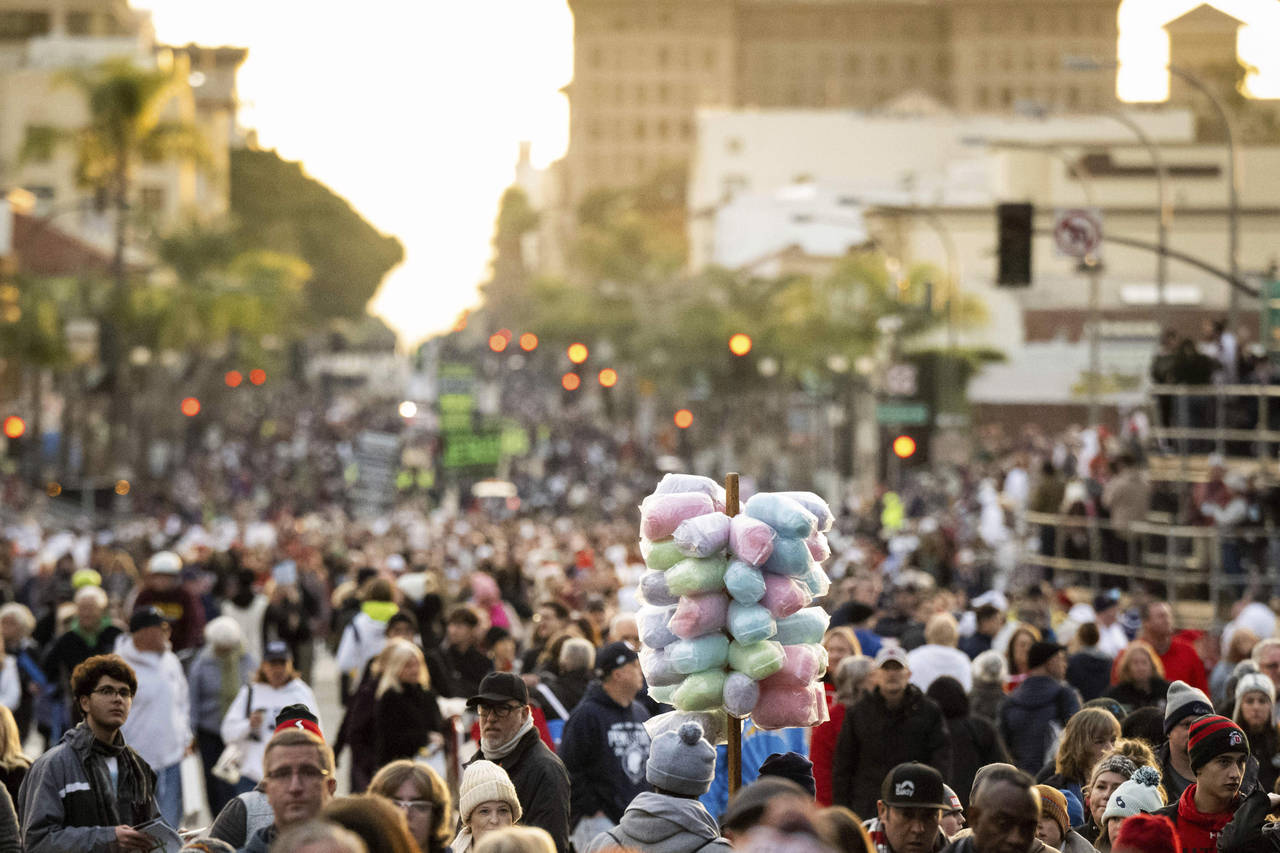 A vendor sells cotton candy along the 134th Rose Parade route in Pasadena, Calif., Monday, Jan. 2, ...