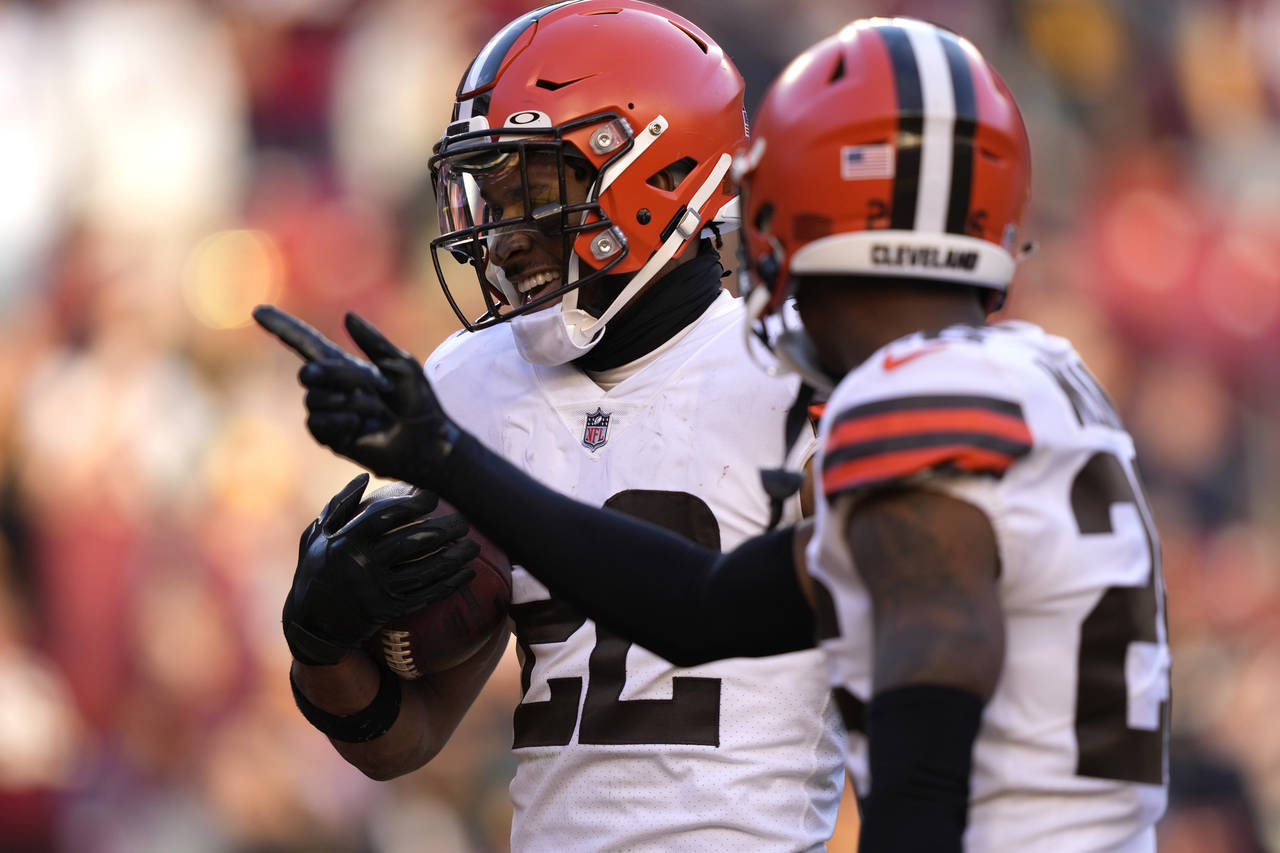Cleveland Browns safety Grant Delpit (22) celebrates his interception with cornerback Greedy Willia...