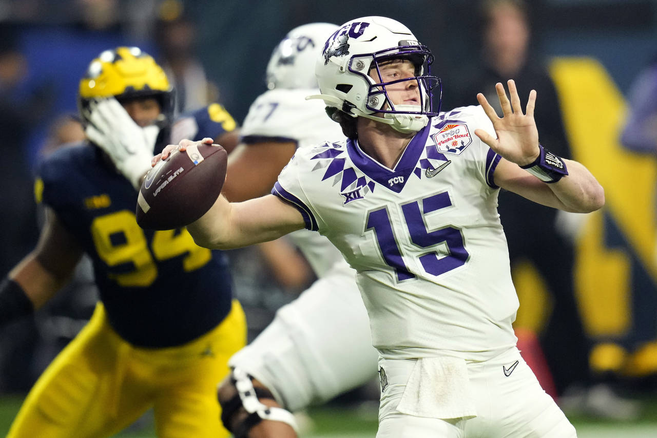 TCU quarterback Max Duggan (15) throws against Michigan during the first half of the Fiesta Bowl NC...