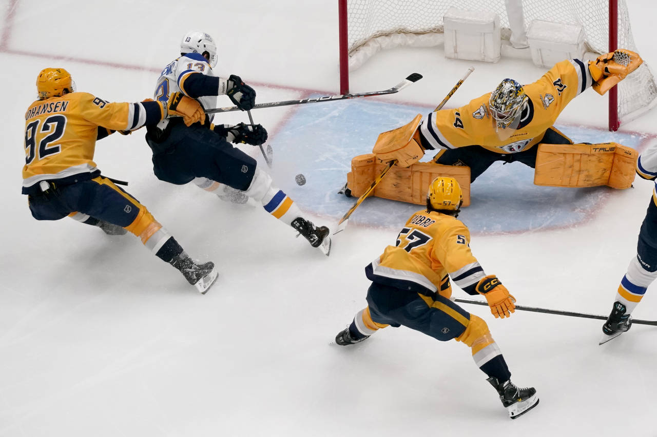 St. Louis Blues' Alexey Toropchenko (13) scores past Nashville Predators goaltender Juuse Saros (74...