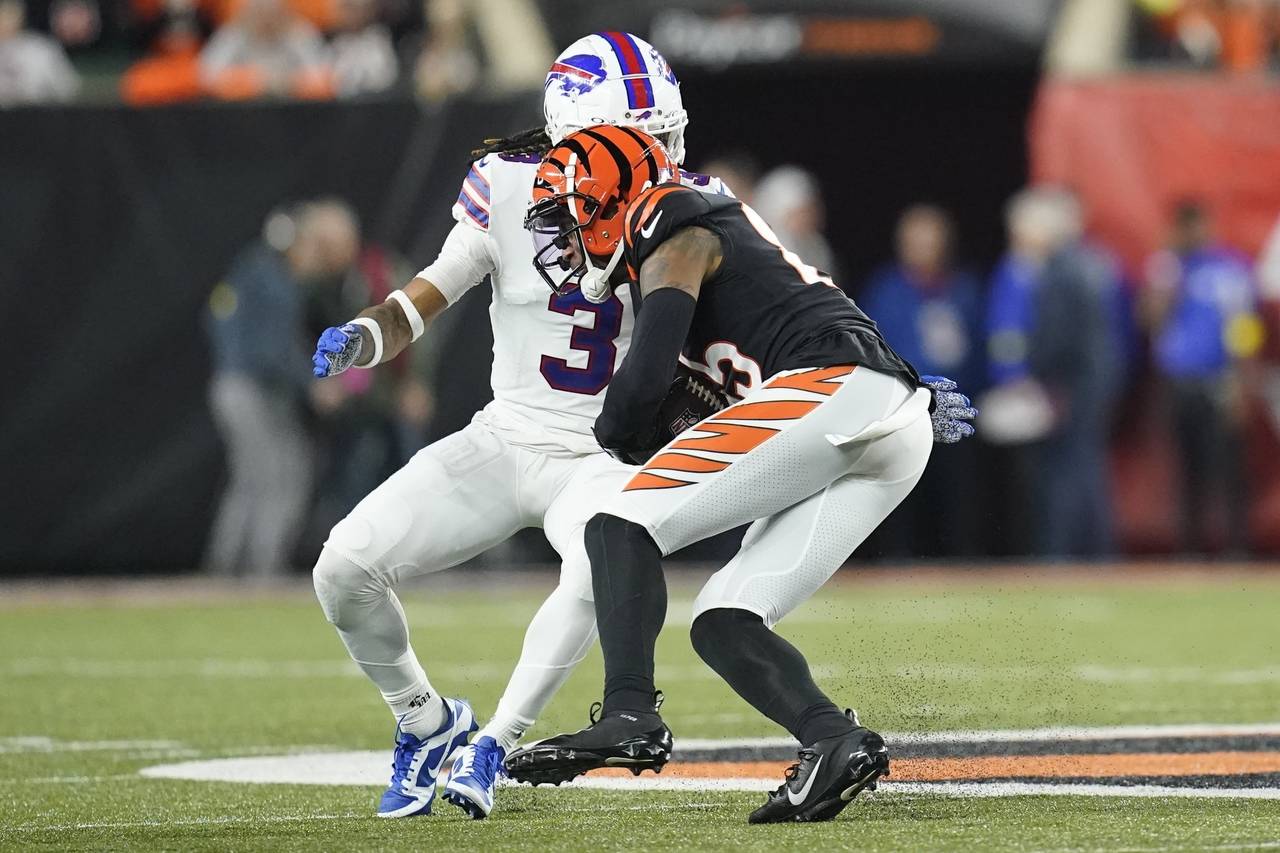Cincinnati Bengals wide receiver Tee Higgins (85) runs near Buffalo Bills safety Damar Hamlin (3) d...