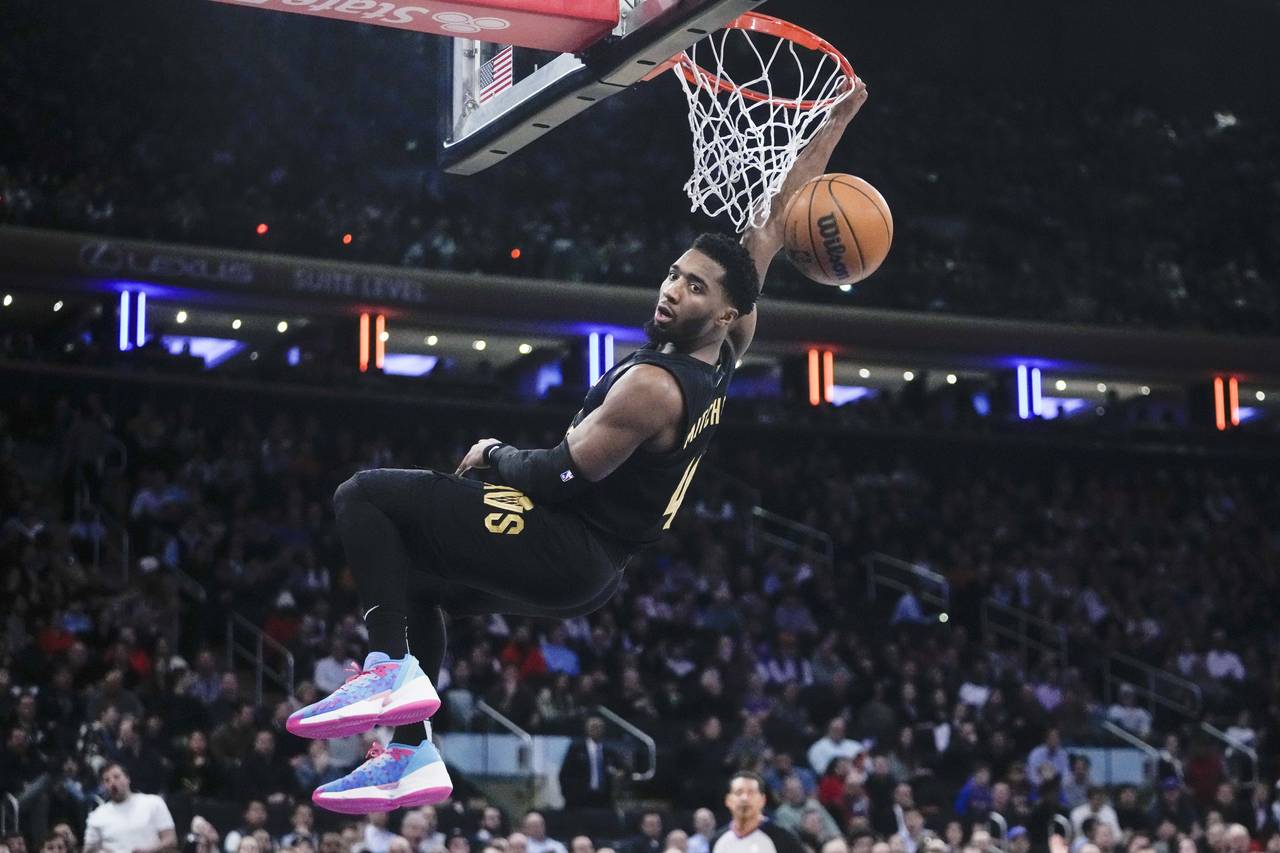 Cleveland Cavaliers' Donovan Mitchell (45) dunks the ball during the first half of an NBA basketbal...
