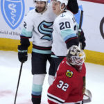 
              Seattle Kraken's Eeli Tolvanen (20) celebrates his goal with Oliver Bjorkstrand as Chicago Blackhawks goaltender Alex Stalock returns to the net during the first period of an NHL hockey game Saturday, Jan. 14, 2023, in Chicago. (AP Photo/Charles Rex Arbogast)
            