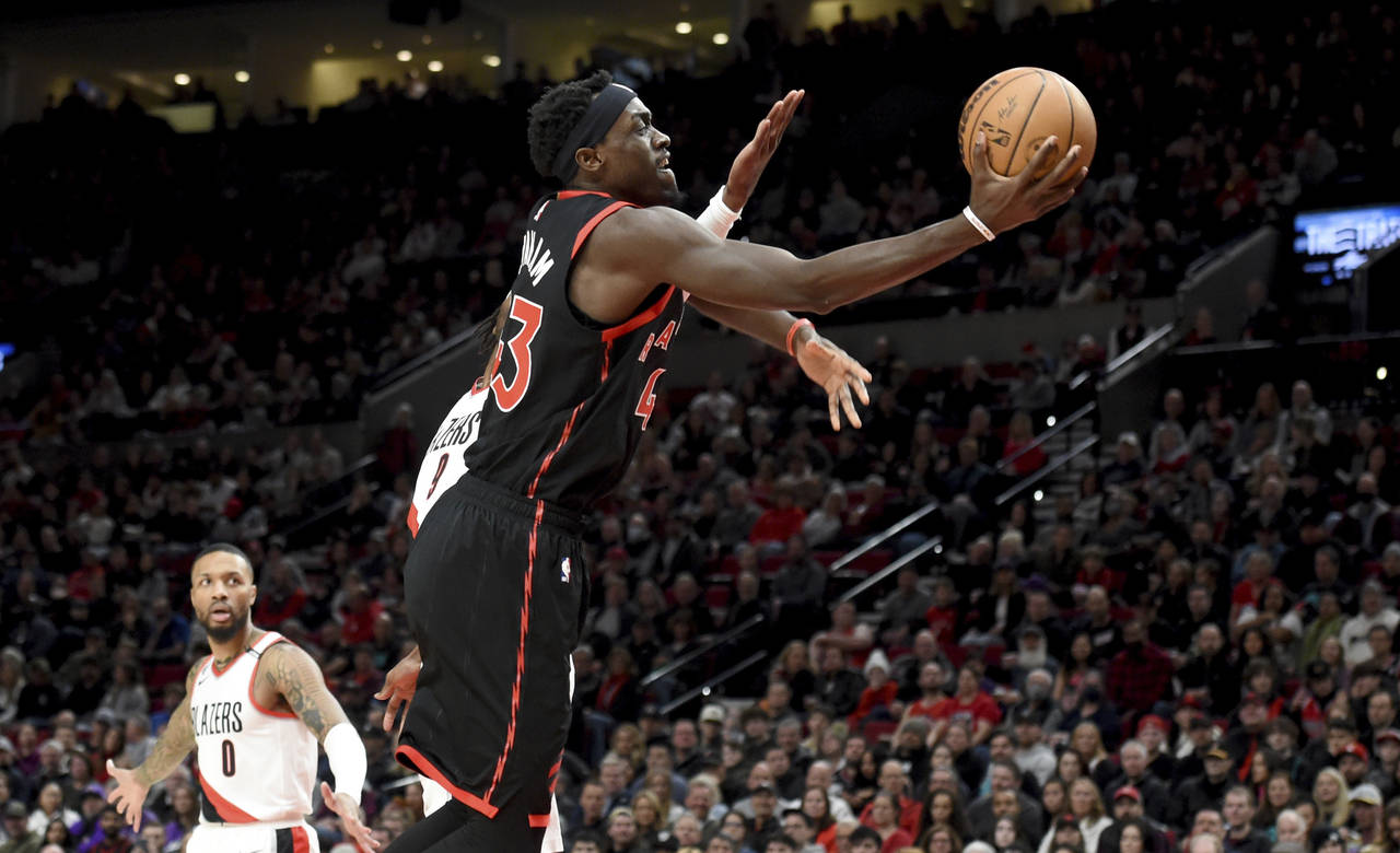 Toronto Raptors forward Pascal Siakam drives to the basket past Portland Trail Blazers forward Jera...