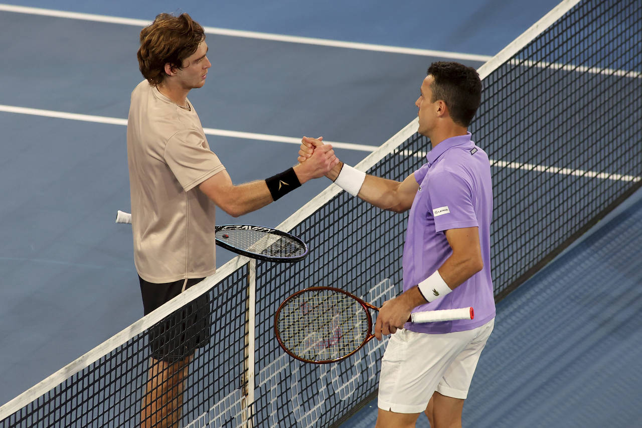 Spain's Roberto Bautista Agut, right, shakes hands at the net after defeating Russia's Andrey Ruble...
