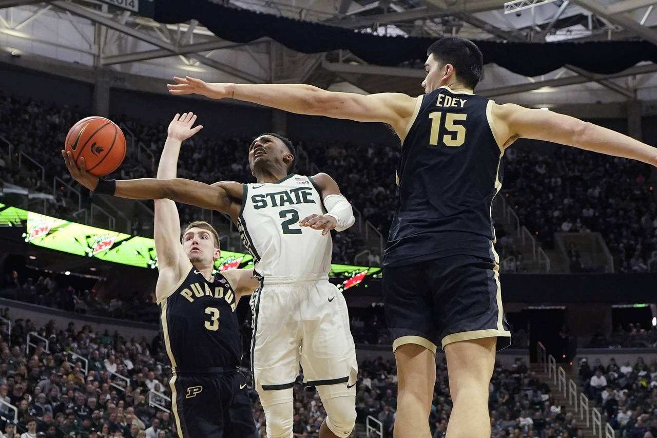 Michigan State guard Tyson Walker (2) attempts a layup as Purdue center Zach Edey (15) defends duri...