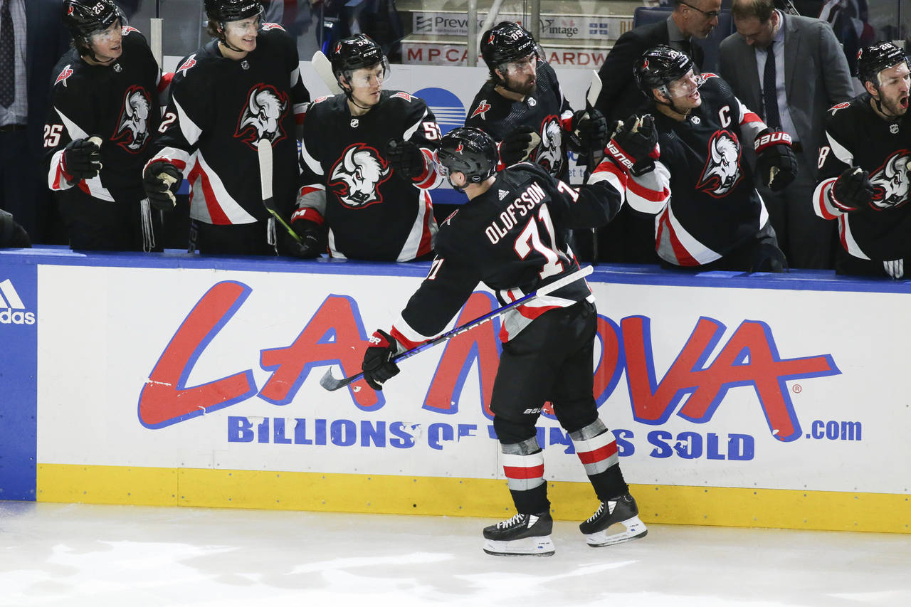 Buffalo Sabres left wing Victor Olofsson (71) celerbates with teammates after scoring a goal during...