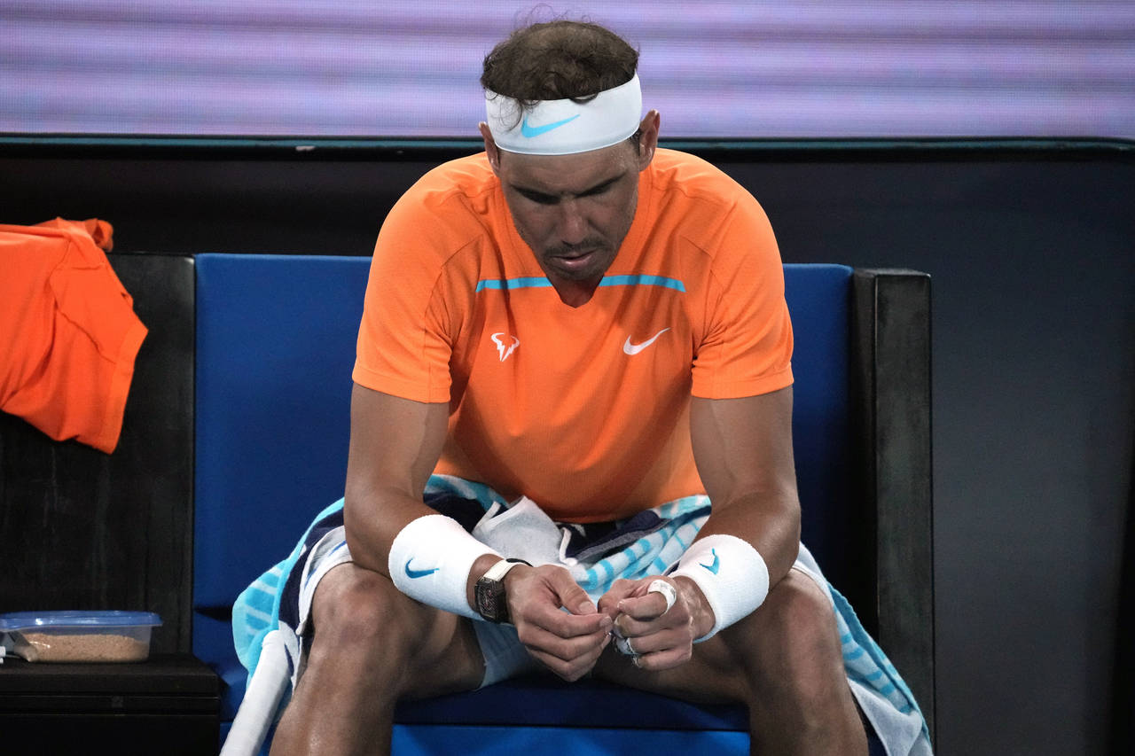 Rafael Nadal of Spain reacts during his second round loss to Mackenzie McDonald of the U.S. at the ...
