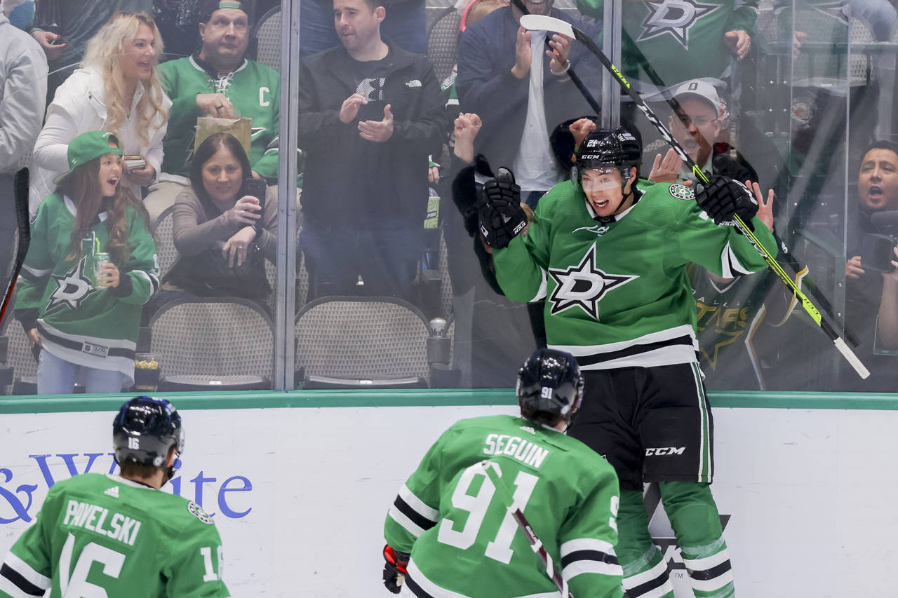 Dallas Stars left wing Jason Robertson, back right, celebrates with teammates Joe Pavelski (16) and...