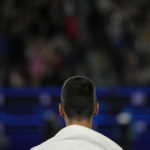Djokovic worried about leg, bothered by heckler in Australia