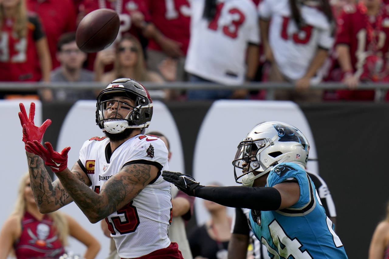 Tampa Bay Buccaneers wide receiver Mike Evans scores in front of Carolina Panthers cornerback CJ He...