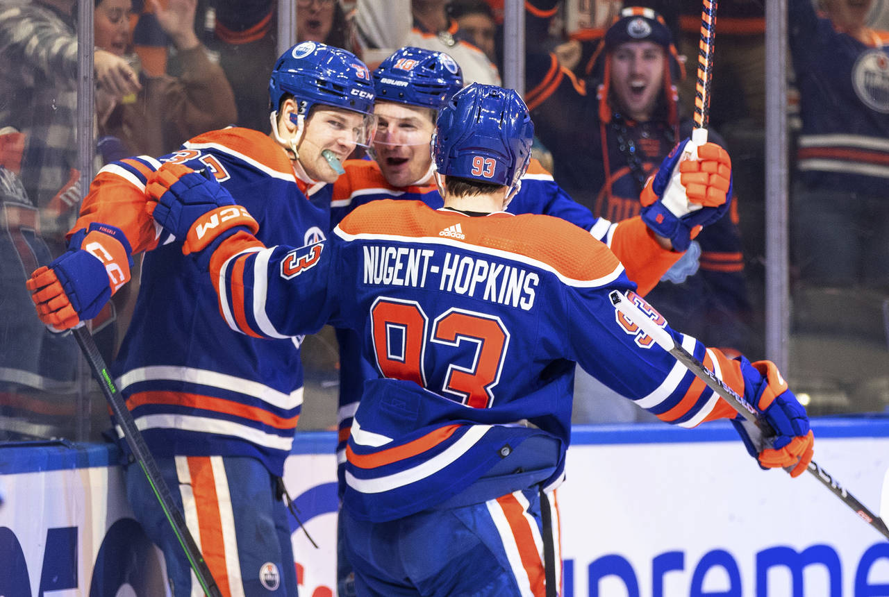 Edmonton Oilers' Warren Foegele (37), Ryan Nugent-Hopkins (93) and Zach Hyman (18) celebrate a goal...