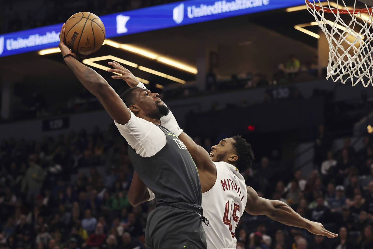 Minnesota Timberwolves center Naz Reid (11) goes to the basket against Cleveland Cavaliers guard Do...