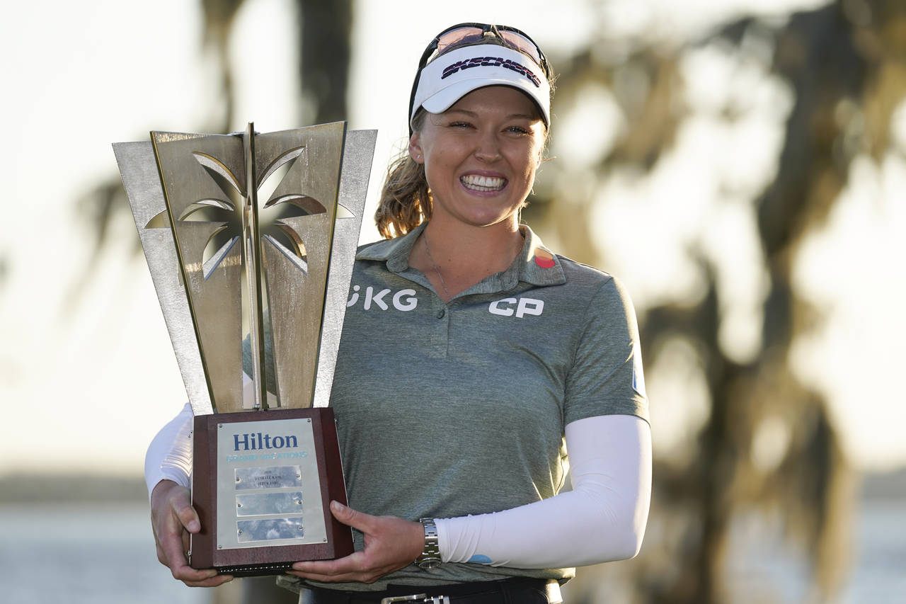 Brooke Henderson holds up the championship trophy after winning the LPGA Hilton Grand Vacations Tou...