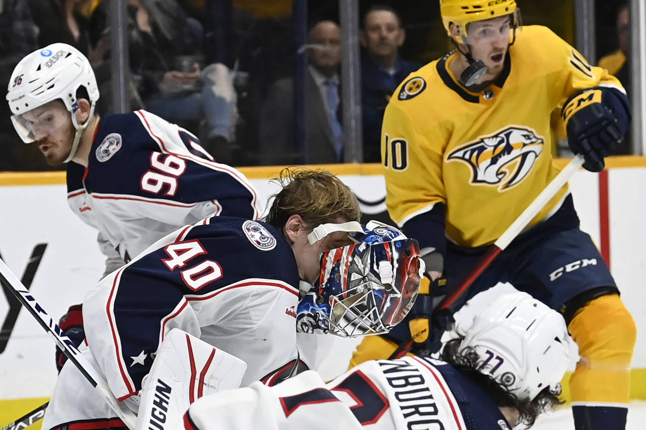 The mask of Columbus Blue Jackets goaltender Daniil Tarasov (40) comes off after he blocked a shot ...