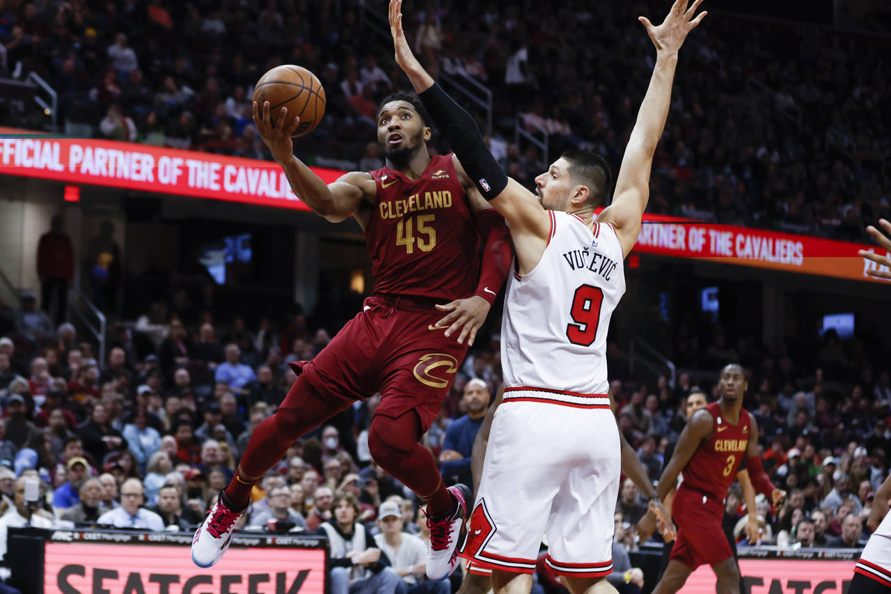 Cleveland Cavaliers guard Donovan Mitchell (45) shoots against Chicago Bulls center Nikola Vucevic ...