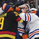 Oilers beat reeling Canucks 4-2 for 6th straight victory.