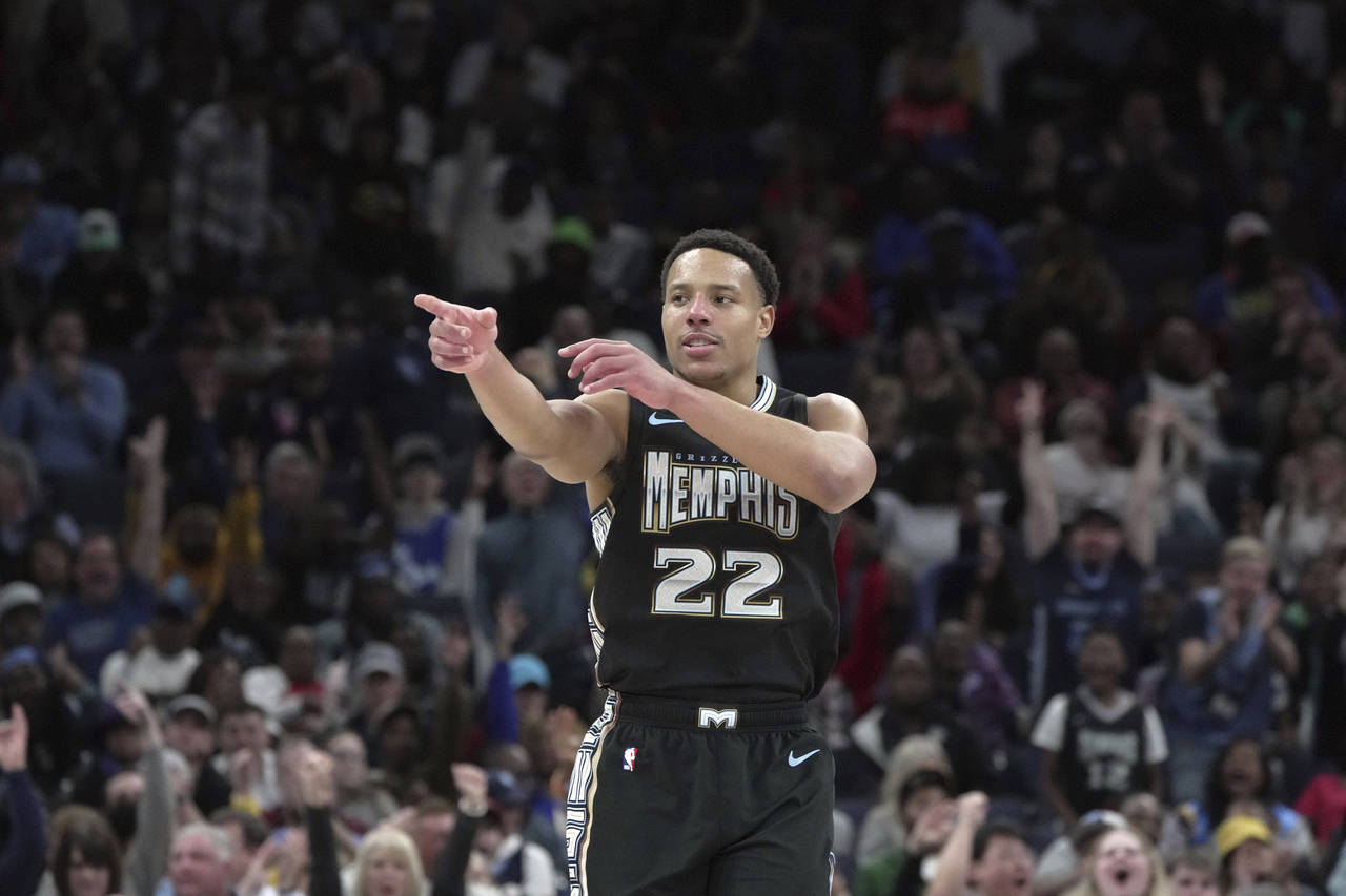 Memphis Grizzlies Desmond Bane (22) reacts after making a basket in the first half of an NBA game a...