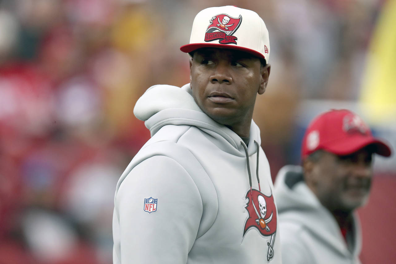 FILE - Tampa Bay Buccaneers offensive coordinator Byron Leftwich walks on the field during an NFL f...