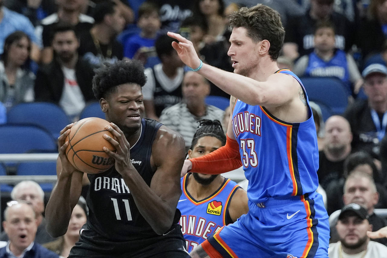 Orlando Magic's Mo Bamba (11) goes to the basket against Oklahoma City Thunder's Mike Muscala (33) ...