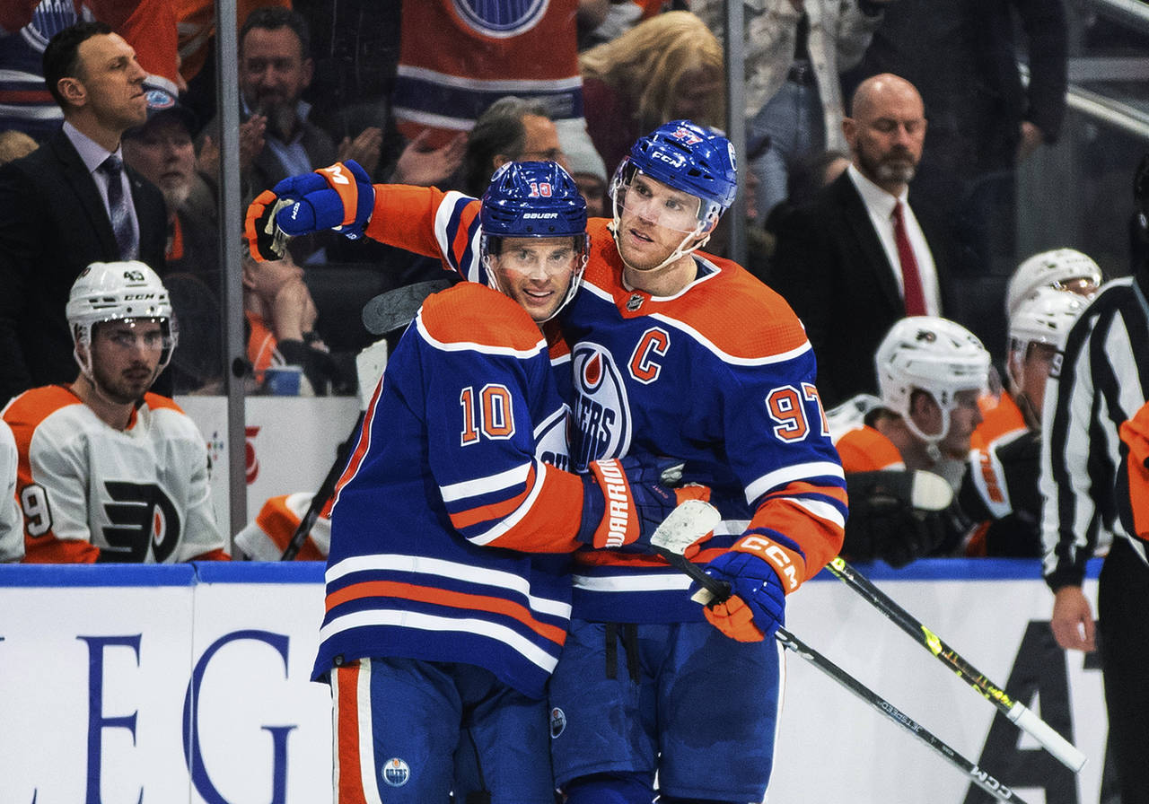 Edmonton Oilers' Derek Ryan (10) and Connor McDavid (97) celebrate a goal against the Philadelphia ...