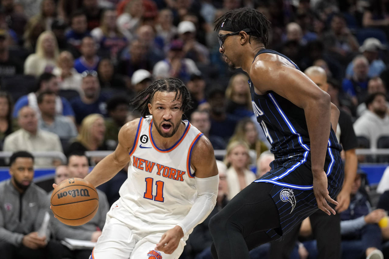 New York Knicks' Jalen Brunson (11) drives around Orlando Magic's Wendell Carter Jr. during the fir...