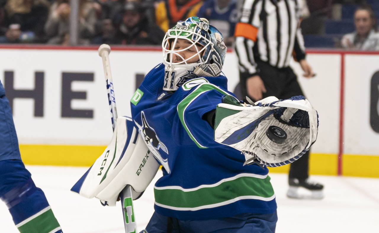 Vancouver Canucks goaltender Arturs Silovs reaches out to make a glove save against the Philadelphi...