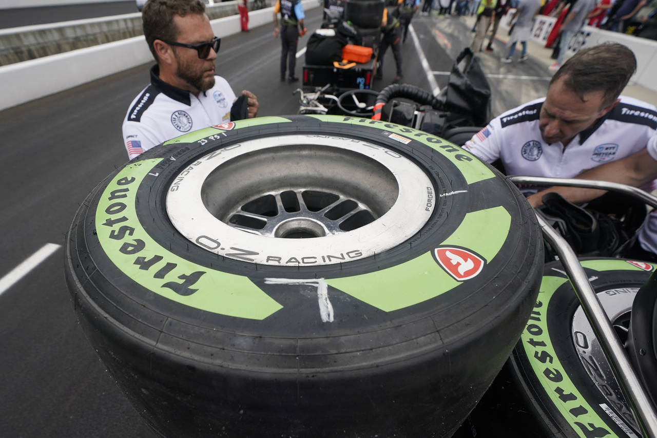FILE - Tires made from natural rubber derived from a desert shrub, sit on a cart before the pit sto...