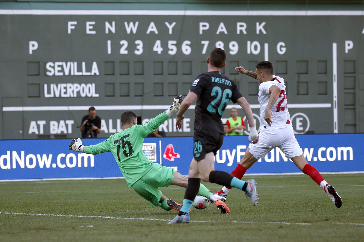 FILE — Liverpool goalie Andy Longergan (75) dives to make a save as Sevilla's Ocampos Lucas Ariel...