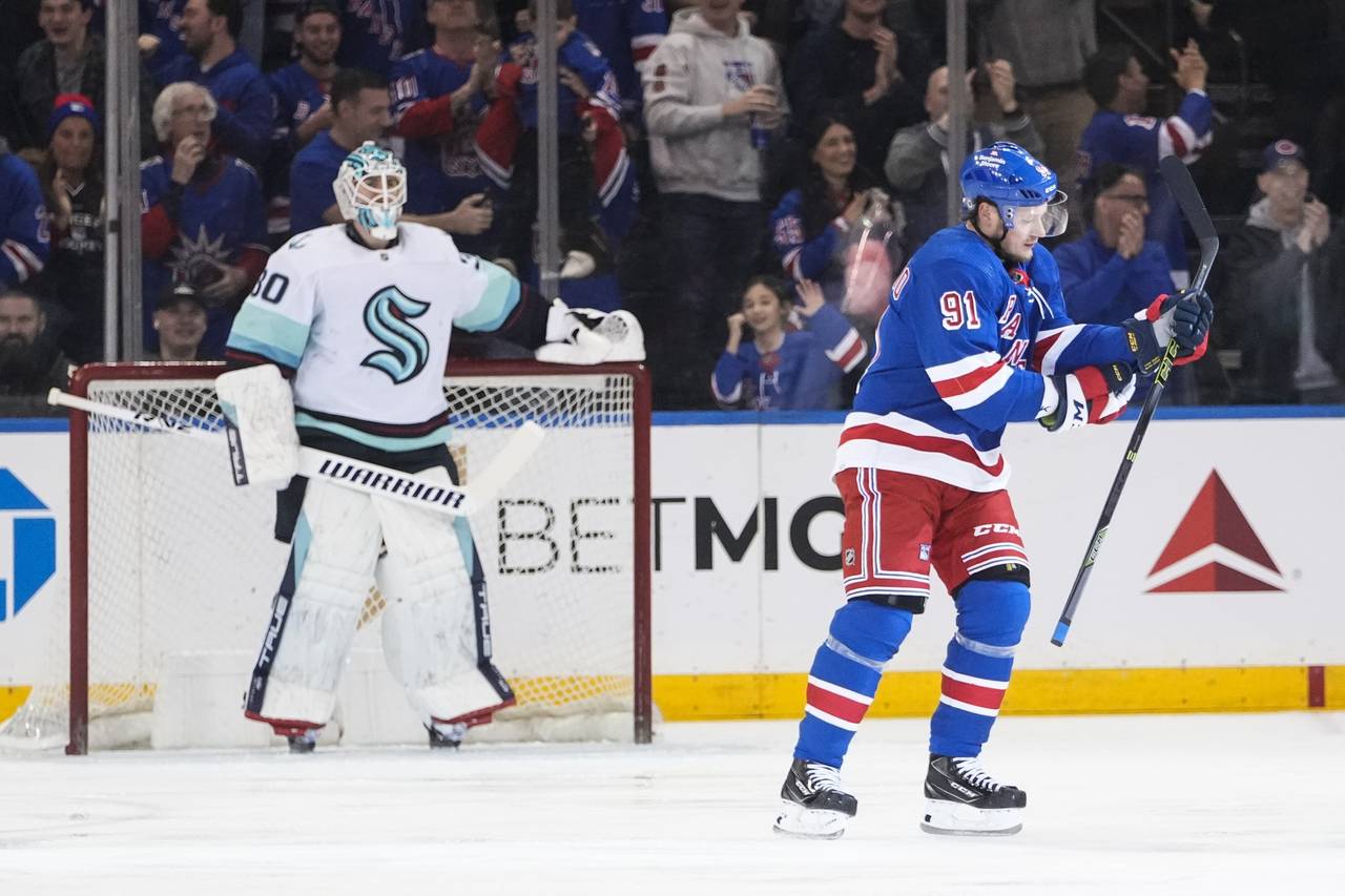 New York Rangers' Vladimir Tarasenko (91) skates past Seattle Kraken goaltender Martin Jones (30) a...