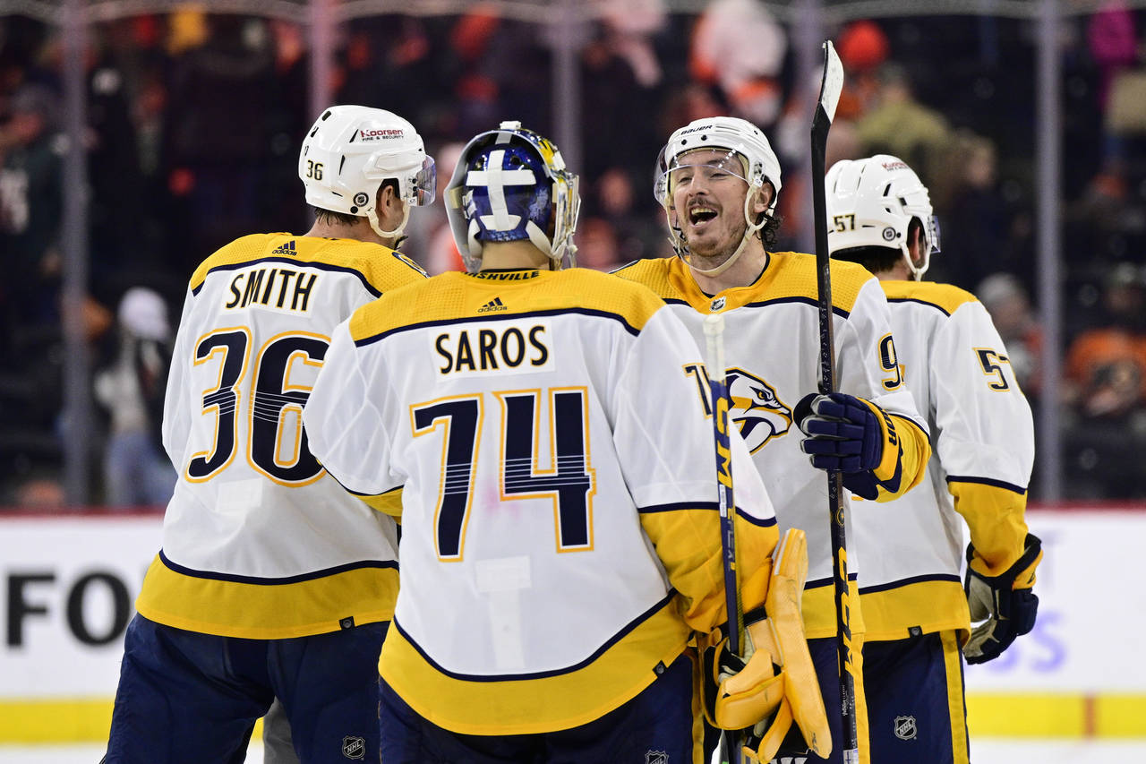 Nashville Predators goaltender Juuse Saros (74) and Matt Duchene, second from right, celebrate afte...