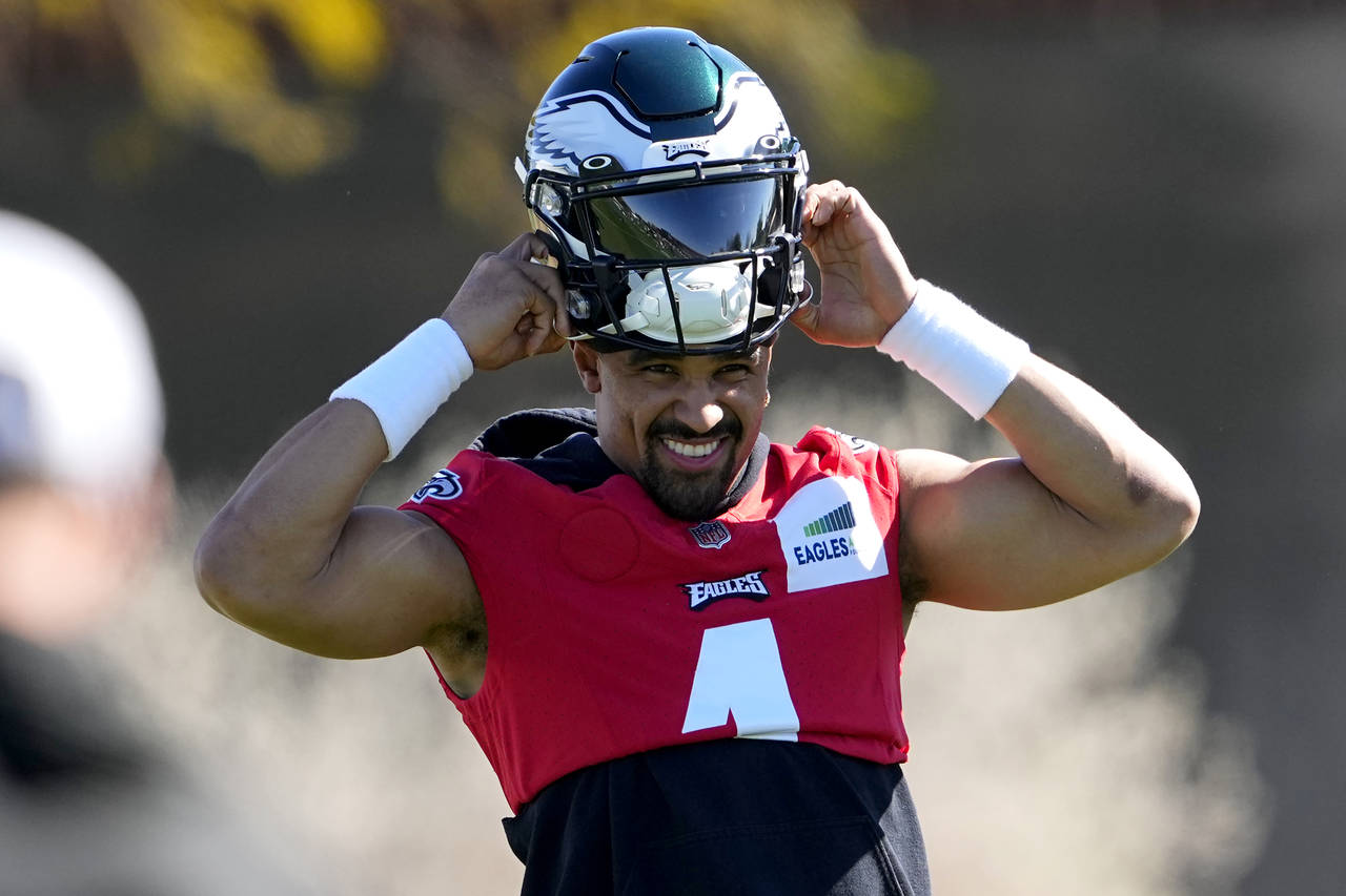 Philadelphia Eagles quarterback Jalen Hurts (1) puts on his helmet during an NFL football Super Bow...