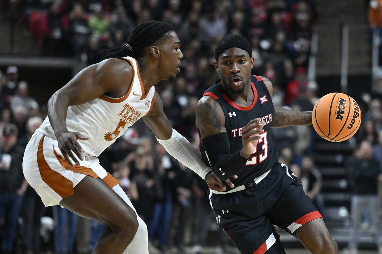 Texas Tech guard De'Vion Harmon (23) brings the ball upcourt against Texas guard Marcus Carr (5) du...