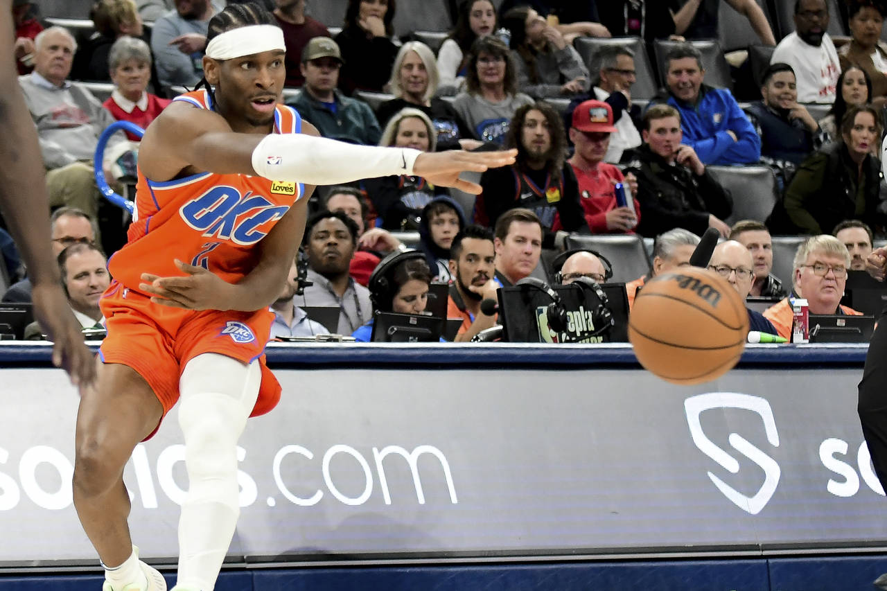 Oklahoma City Thunder guard Shai Gilgeous-Alexander passes the ball in the second half of an NBA ba...