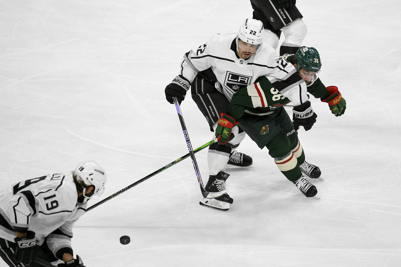 Los Angeles Kings left wing Kevin Fiala (22) and Minnesota Wild right wing Mats Zuccarello (36) bat...