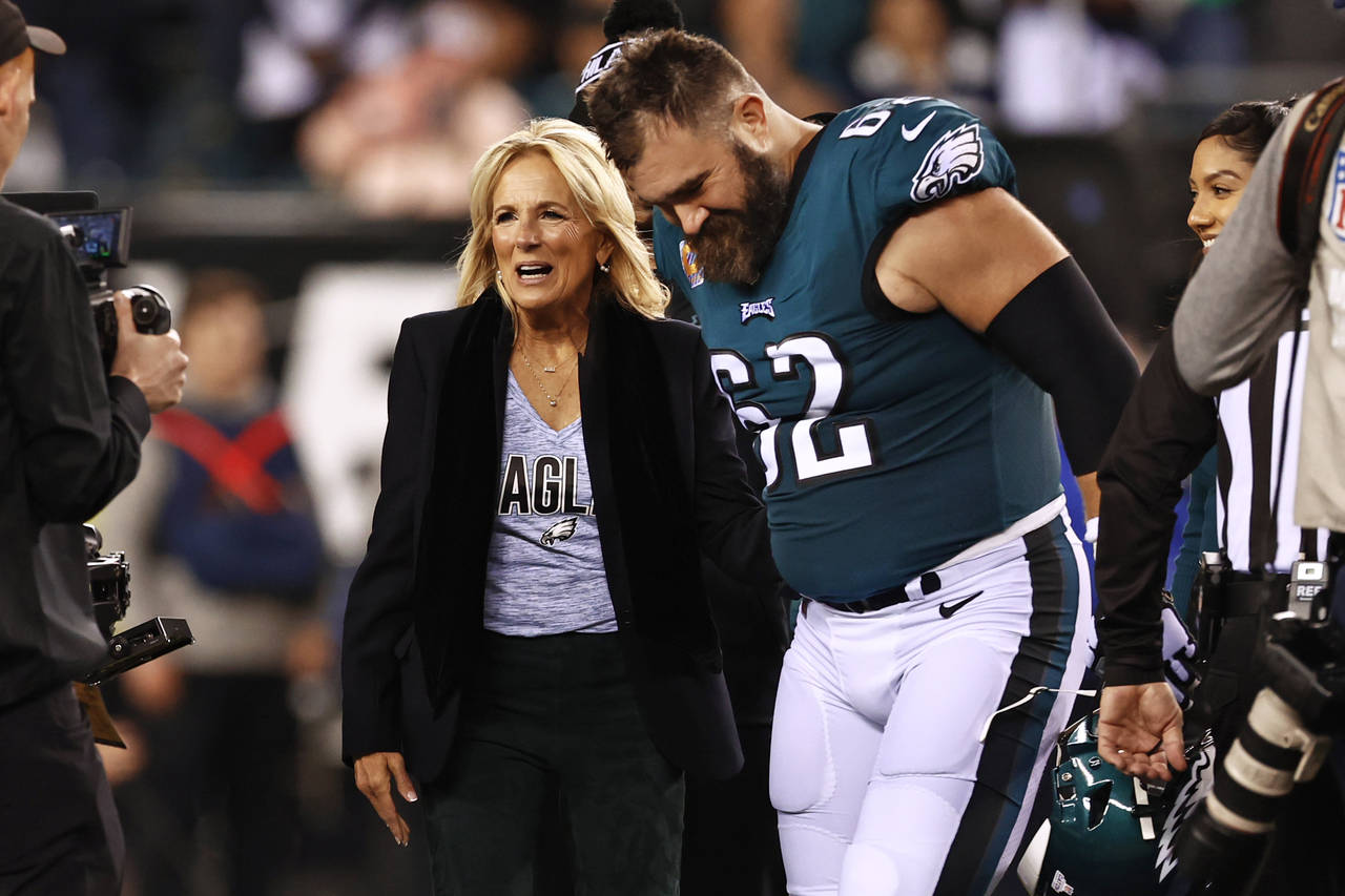 FILE - First lady Jill Biden talks with Philadelphia Eagles center Jason Kelce (62) before the coin...