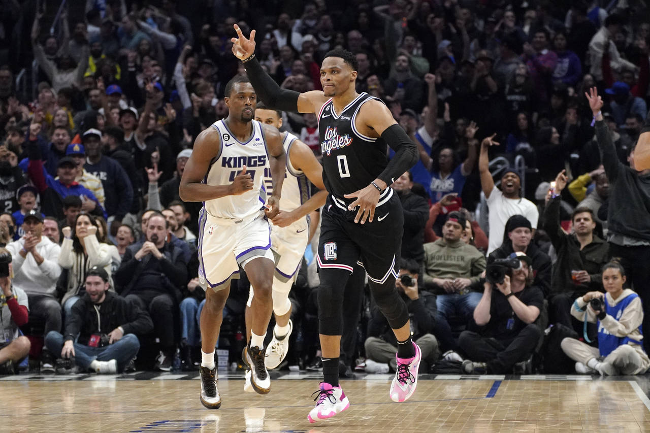Los Angeles Clippers guard Russell Westbrook, right, celebrates after scoring as Sacramento Kings f...