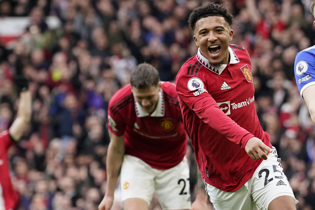 Manchester United's Jadon Sancho celebrates after scoring his side's third goal during the English ...