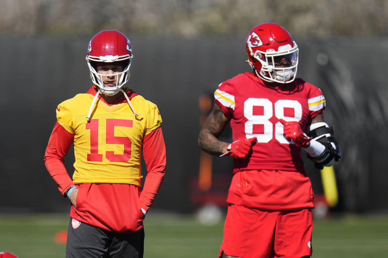 Kansas City Chiefs quarterback Patrick Mahomes (15) pauses on the field with tight end Jody Fortson...
