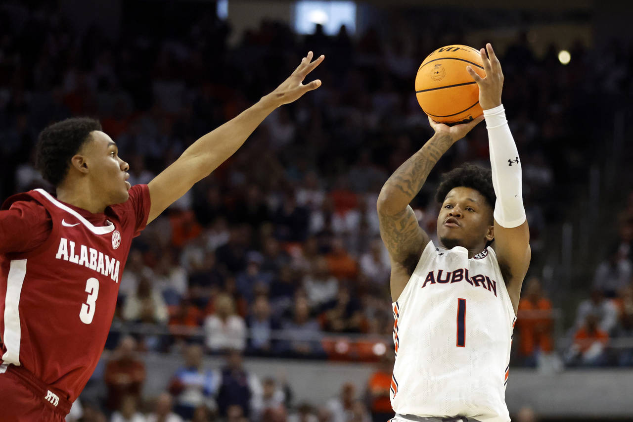 Auburn guard Wendell Green Jr. (1) shoots a three pointer as Alabama guard Rylan Griffen (3) defend...